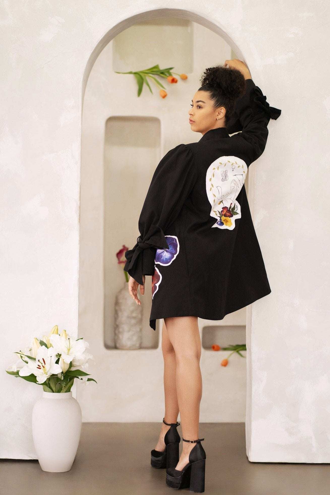 Women wearing Capricorn zodiac jacket with hand-painted astrological patches
