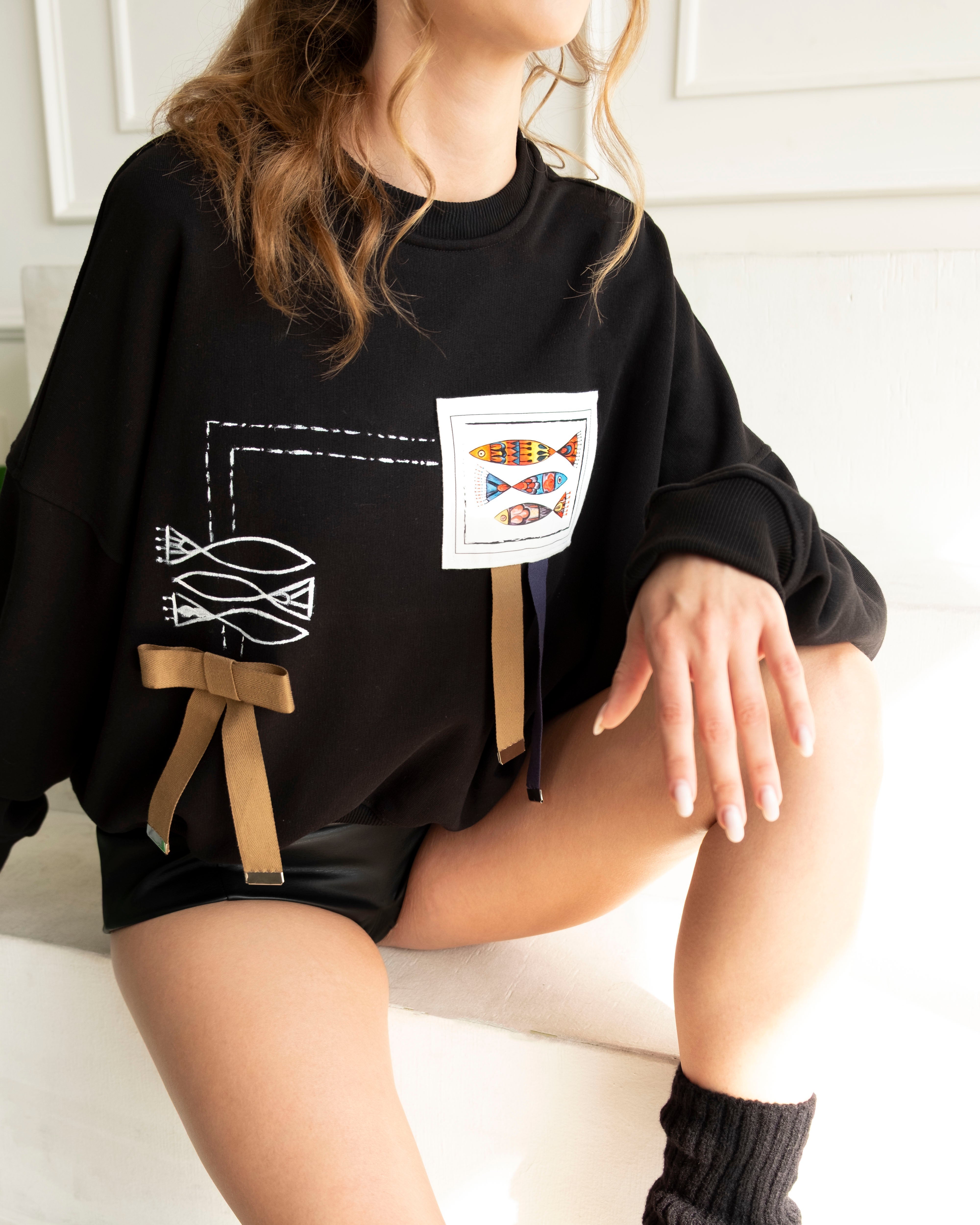 Hand-Painted Fish Crewneck with artistic fish motifs and ribbon details on cropped cotton French terry sweatshirt