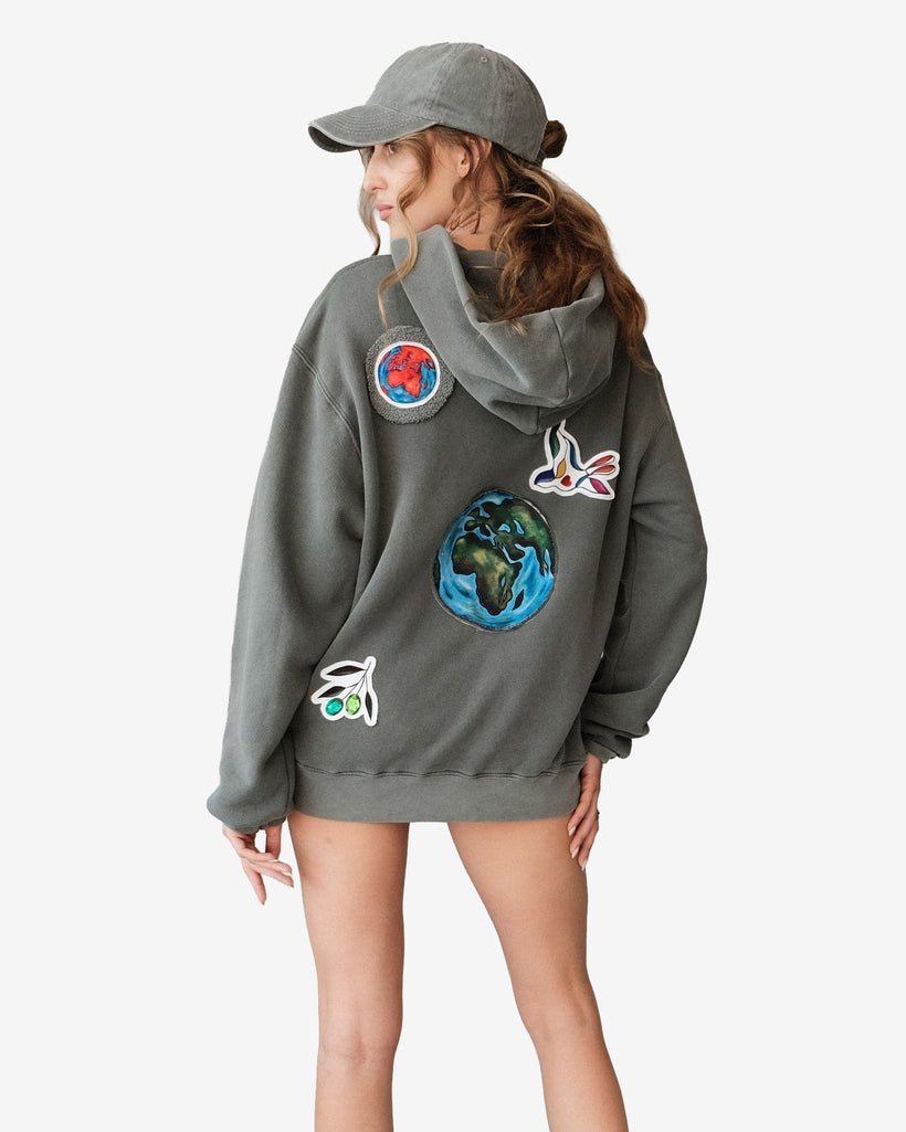Peace World Patchwork Hoodie with Earth and bird motifs symbolizing unity, made of 100% cotton French terry, designed in Los Angeles.