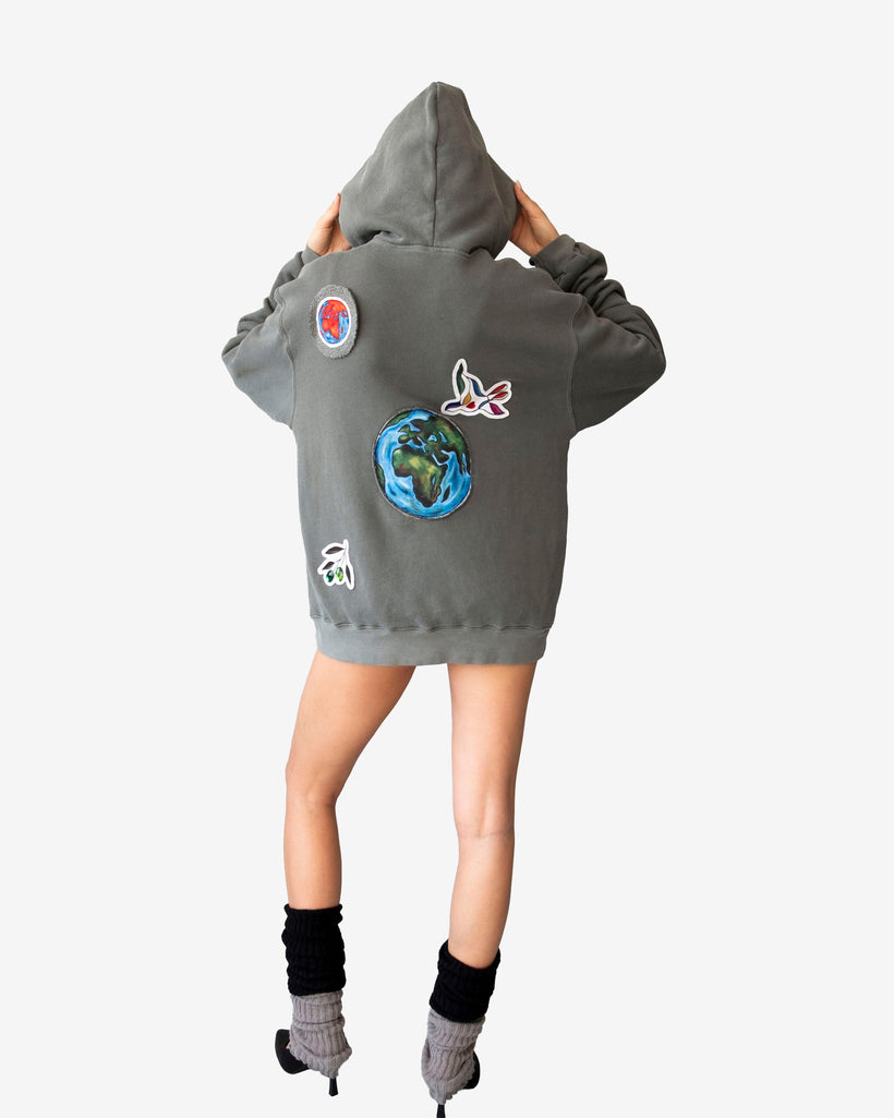 Peace World Patchwork Hoodie with Earth and bird motifs, made of 100% cotton French terry, featuring a relaxed silhouette and peace-themed patchwork design.
