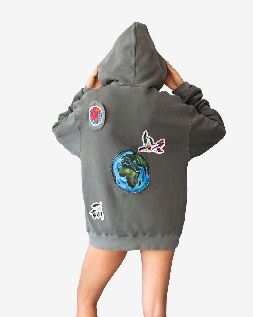 Peace World Patchwork Hoodie with Earth and bird motifs, made of 100% cotton French terry, featuring a relaxed silhouette and peace-themed patchwork design.