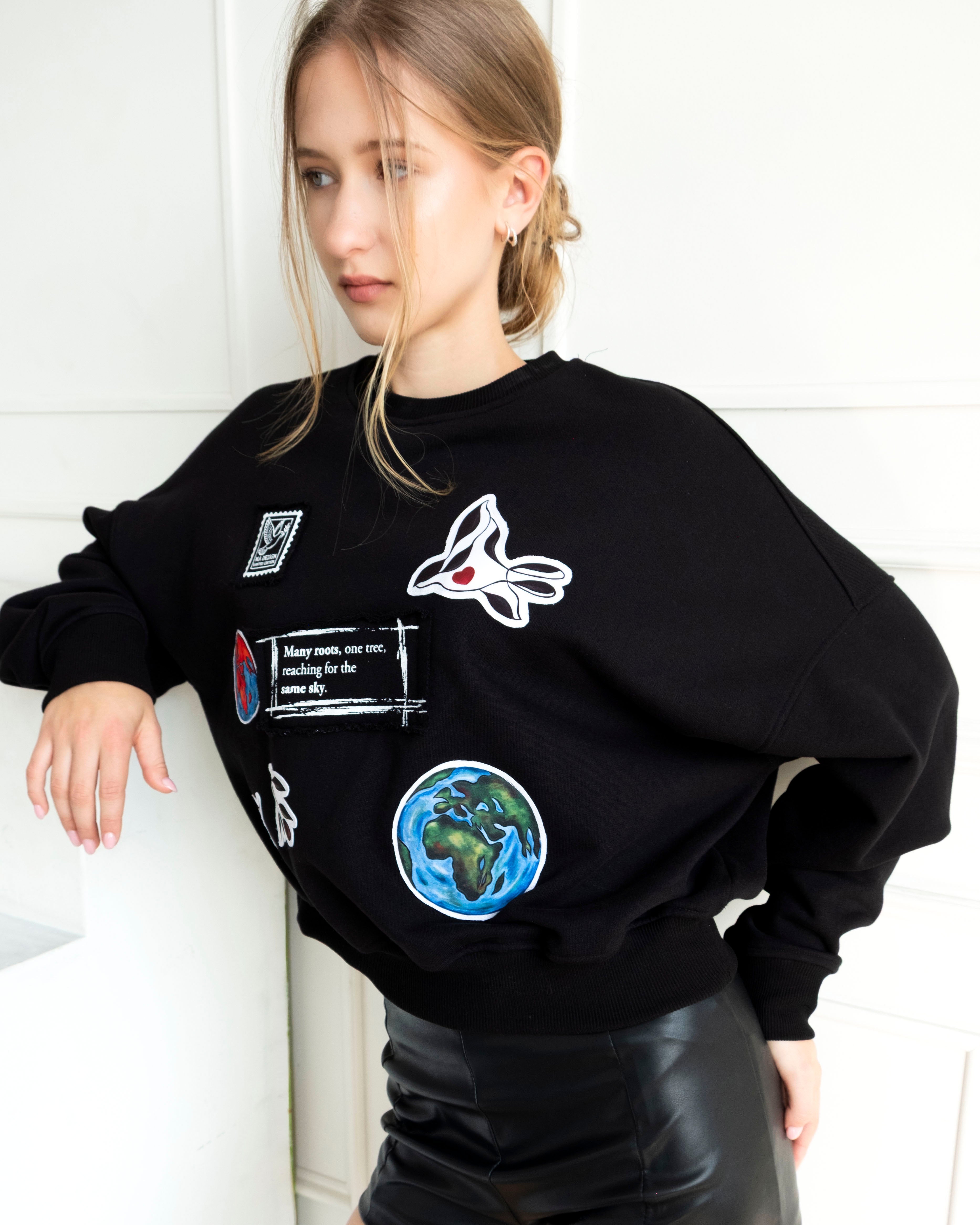Unity World Cropped Crewneck with peace-themed patchwork and Earth motifs on soft 100% cotton French terry