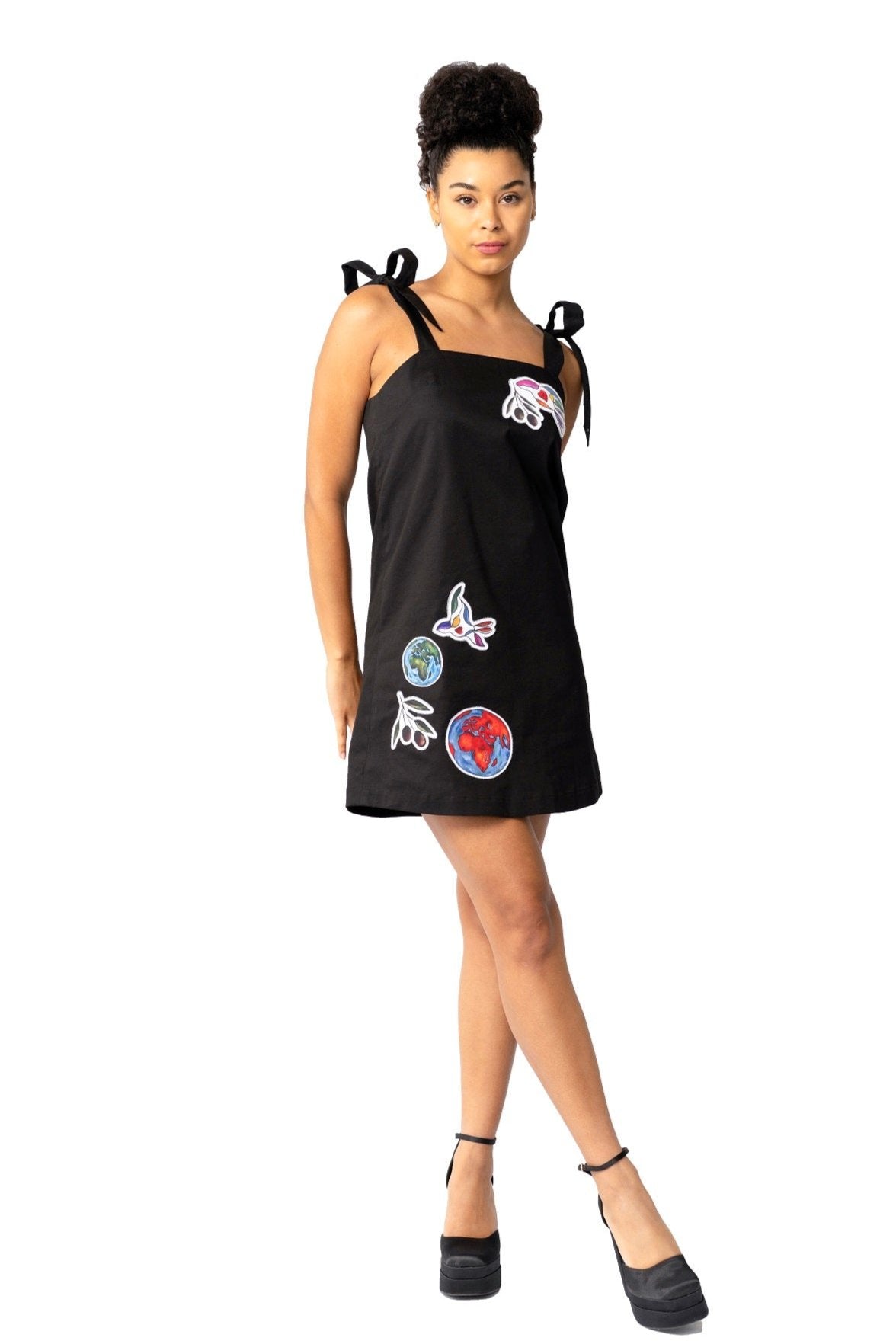 White elegant women's mini dress with hand-painted peace bird design and sleeveless cotton twill fabric
