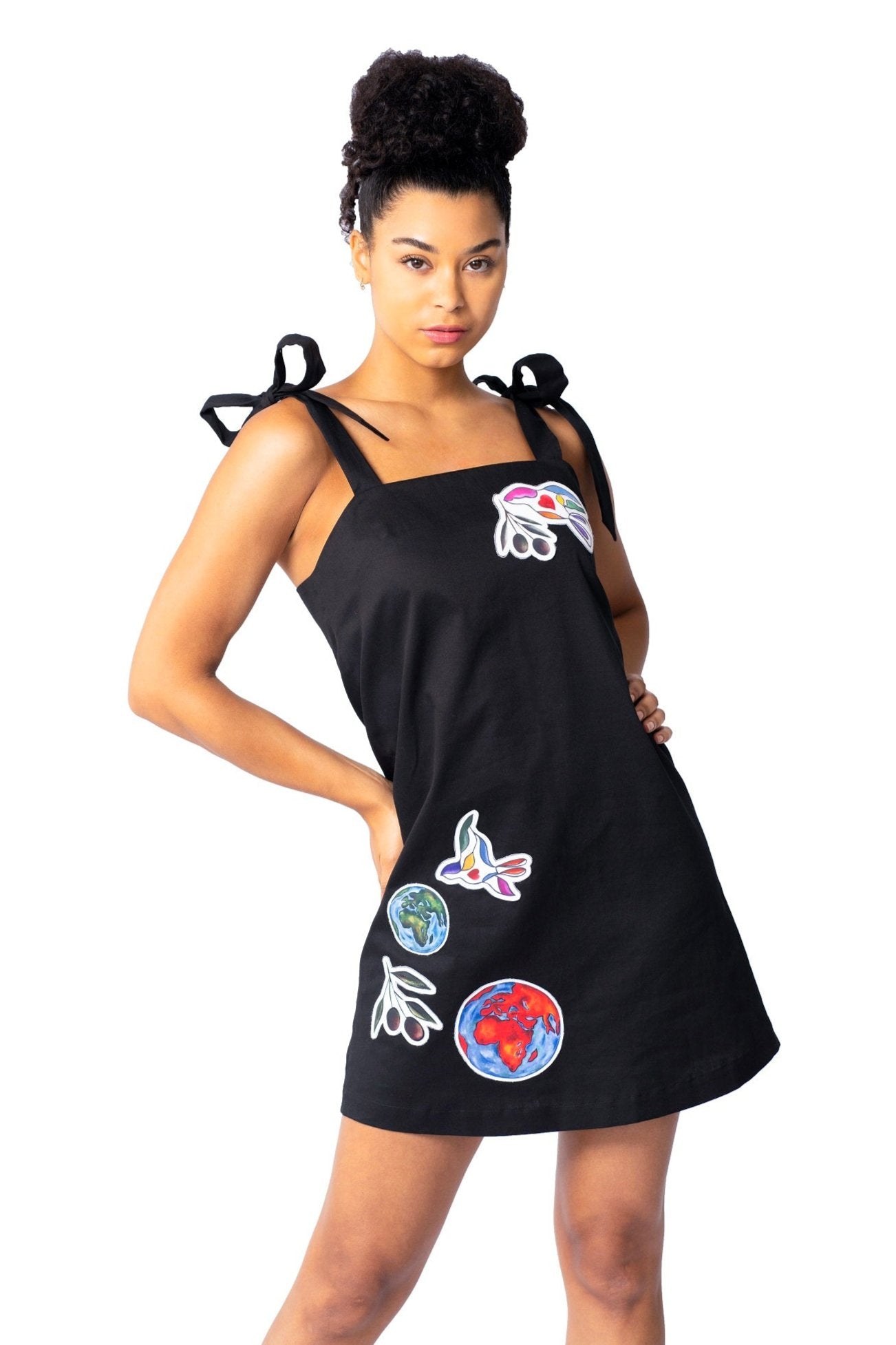 White elegant women's mini dress with hand-painted peace bird design and sleeveless cotton twill fabric