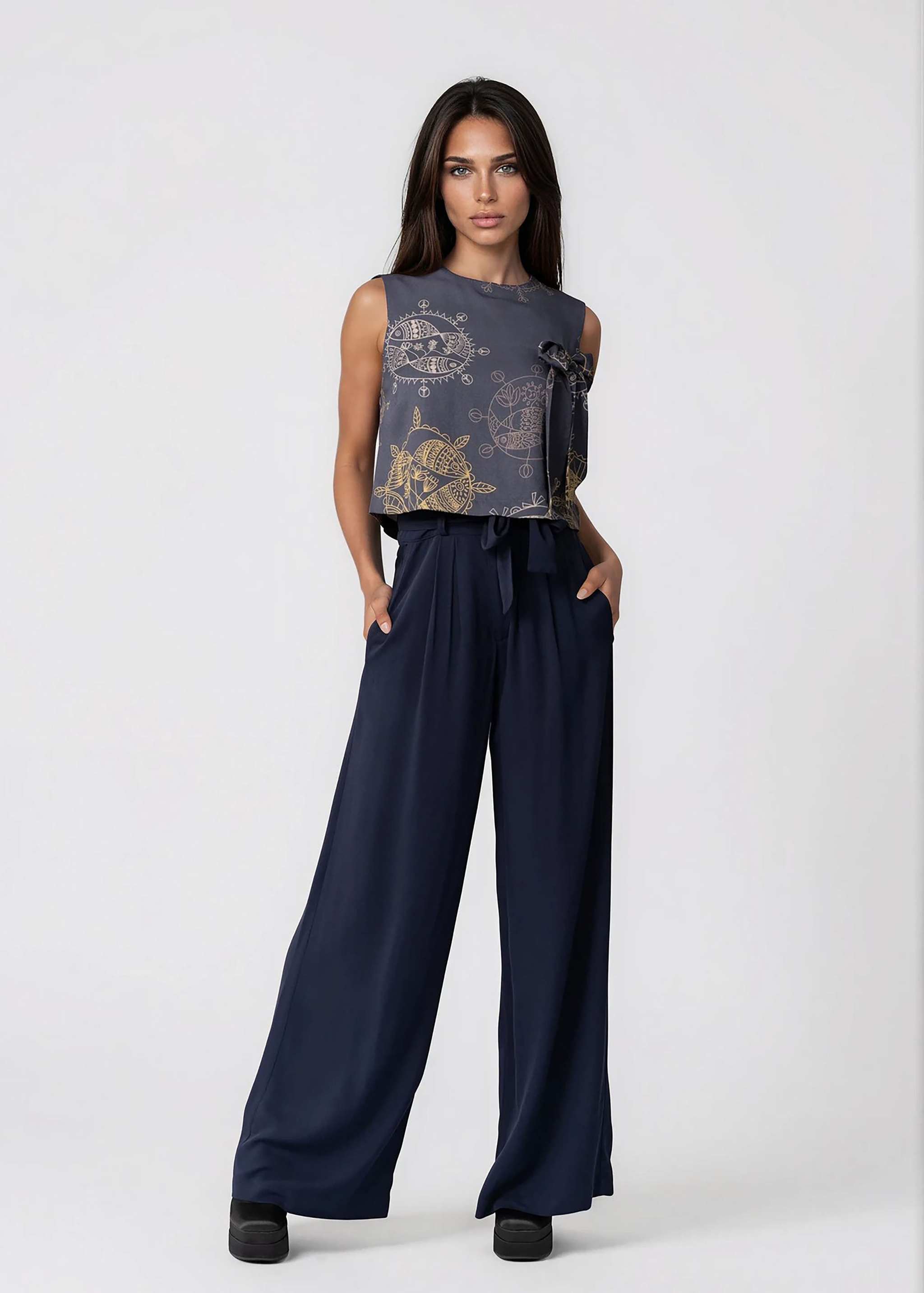 High-waisted wide leg black pants with self-tie belt and pleated front in lightweight twill fabric