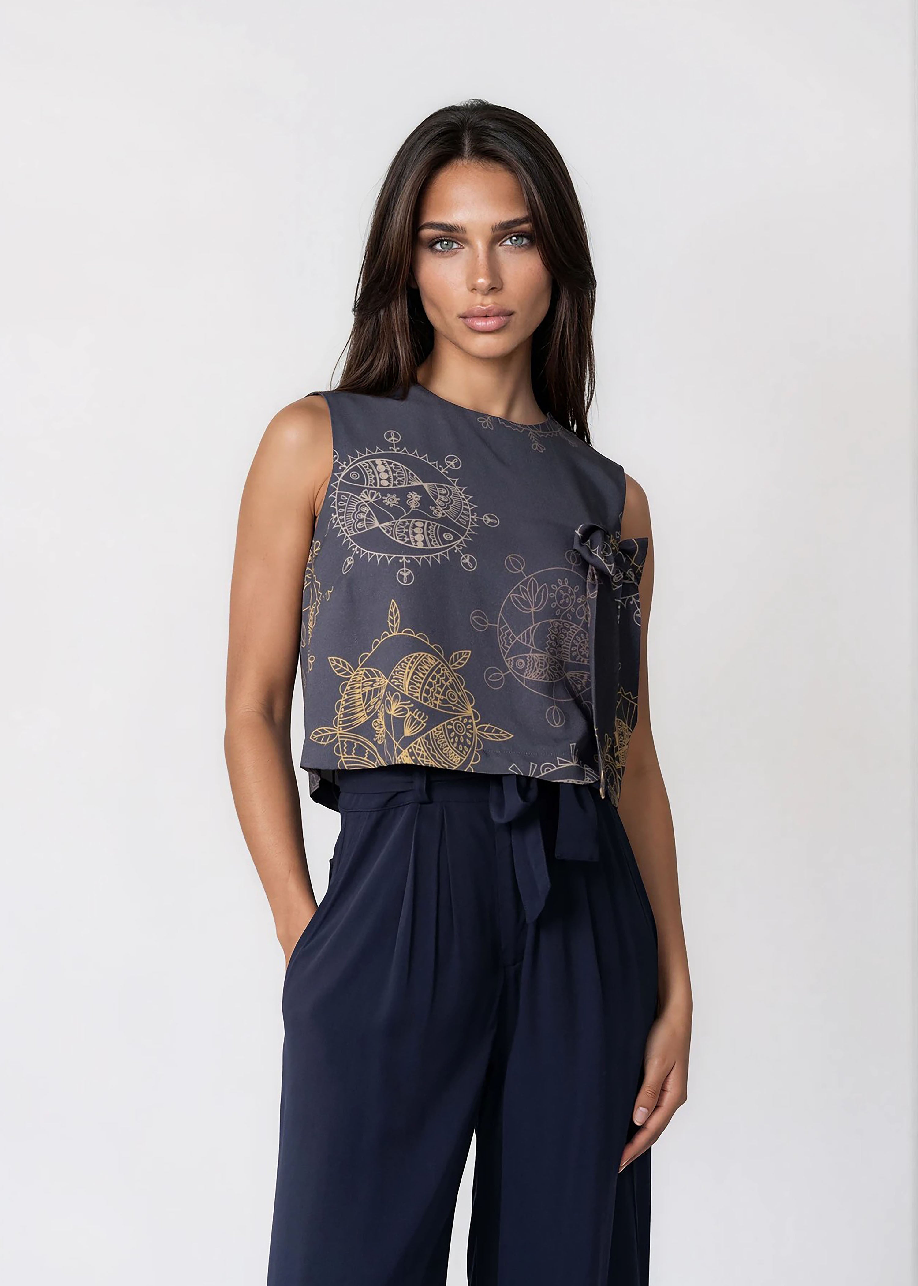 Women's cropped sleeveless bowtie top in midnight blue with round neckline and relaxed fit