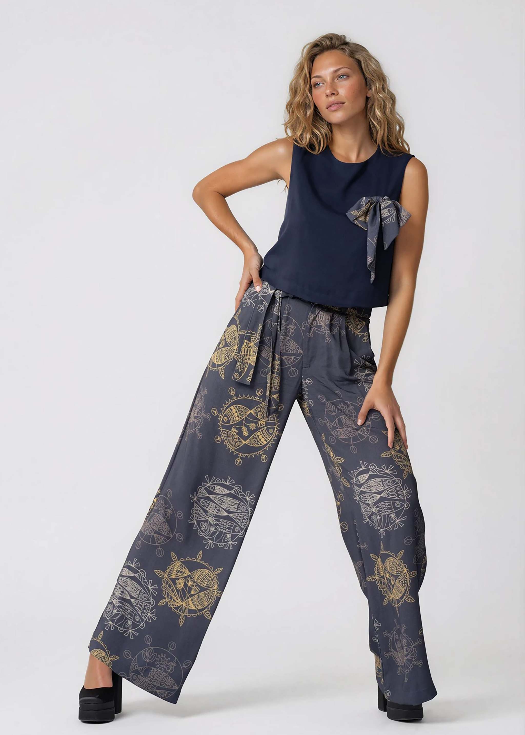 Mid-waisted wide leg pants in midnight ocean print with self-tie belt and pleated front