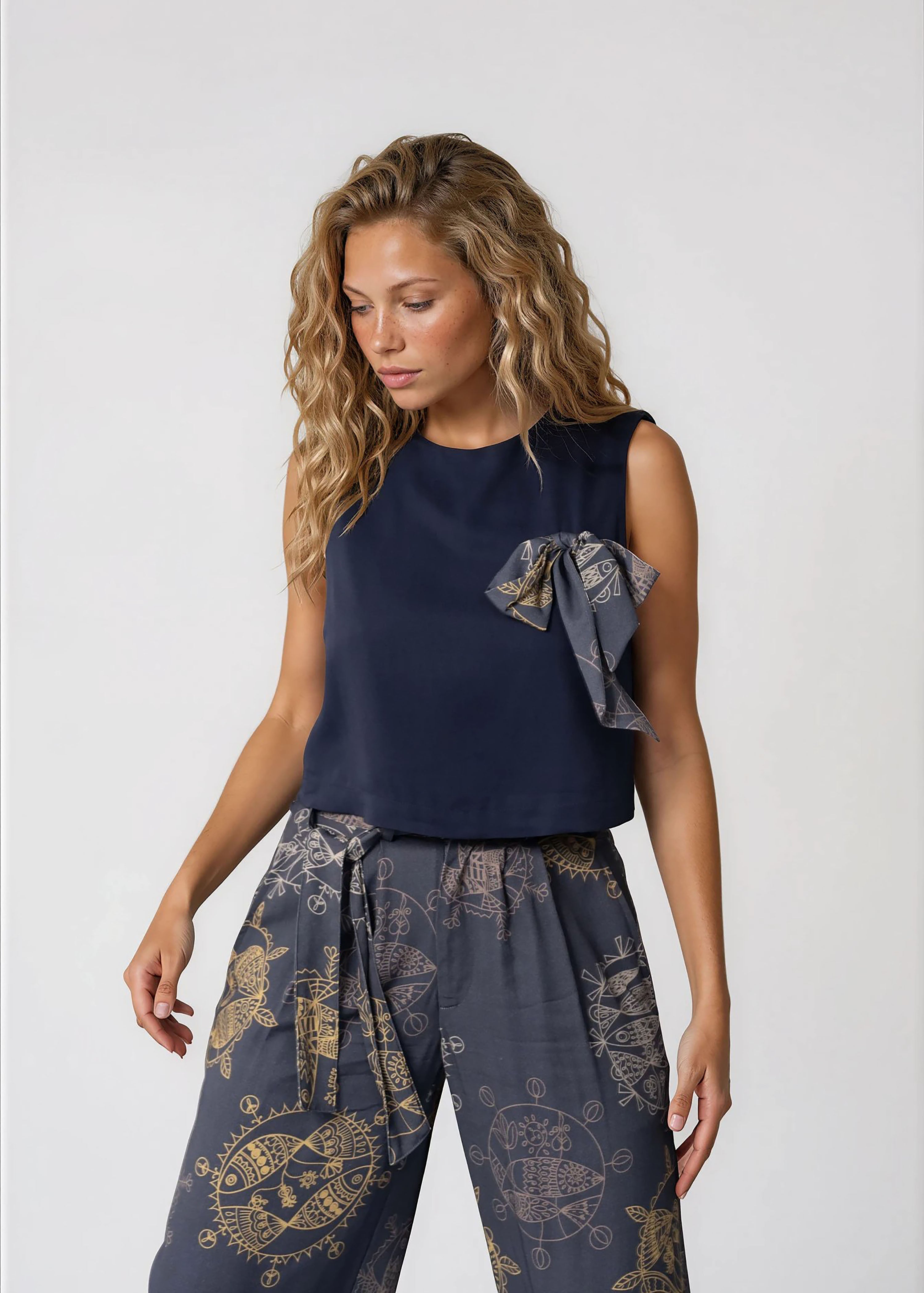 Women's cropped sleeveless bowtie top in midnight blue with round neckline and relaxed fit