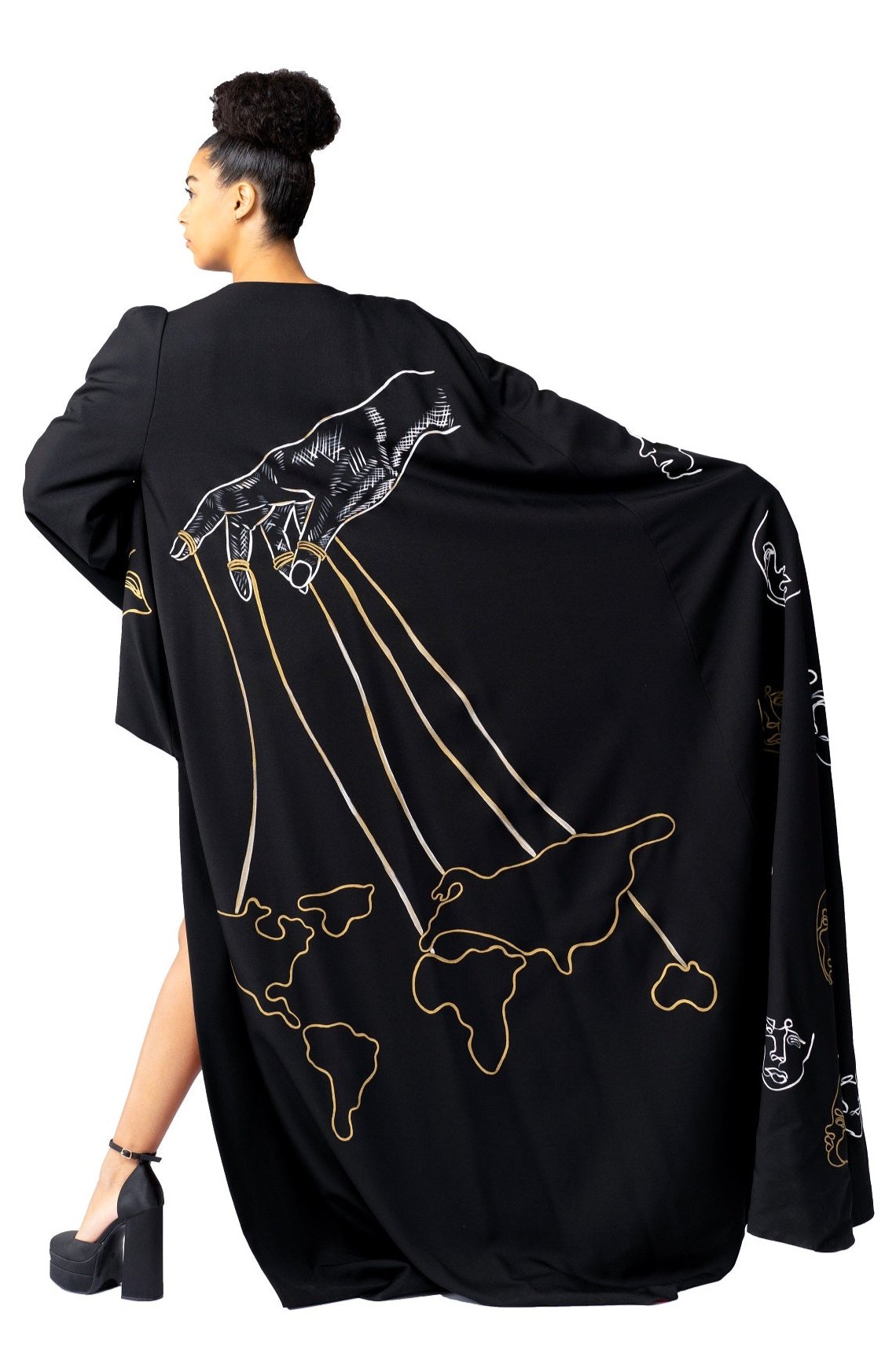Model wearing Invisible Government Asymmetric Cape and Pants with hand-painted world map design