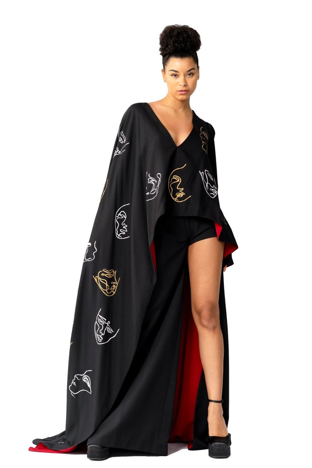 Model wearing Invisible Government asymmetric silk wool cape and one-leg pants with hand-painted world map design