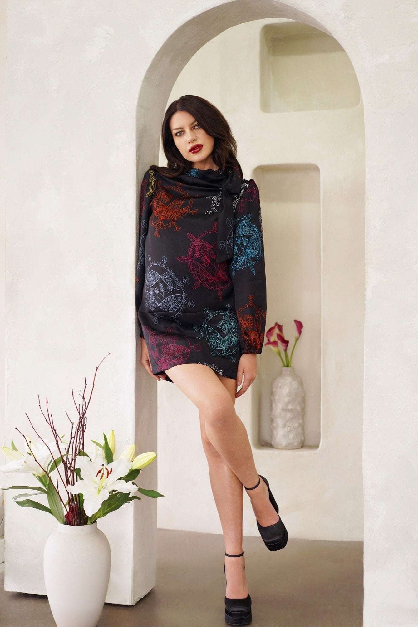 Women wearing a Women High Neck Mini Dress with long bell sleeves and neck tie detail