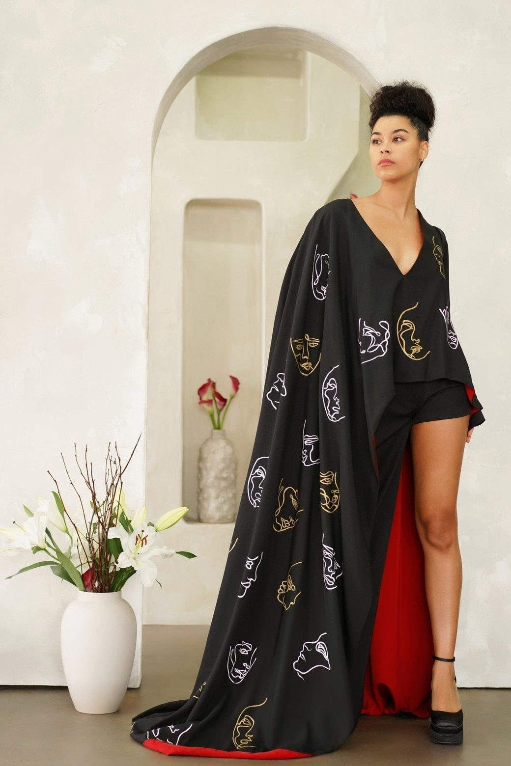 Invisible Government asymmetric cape and pants with hand-painted world map design, wide leg pants, and one-sleeve cape.