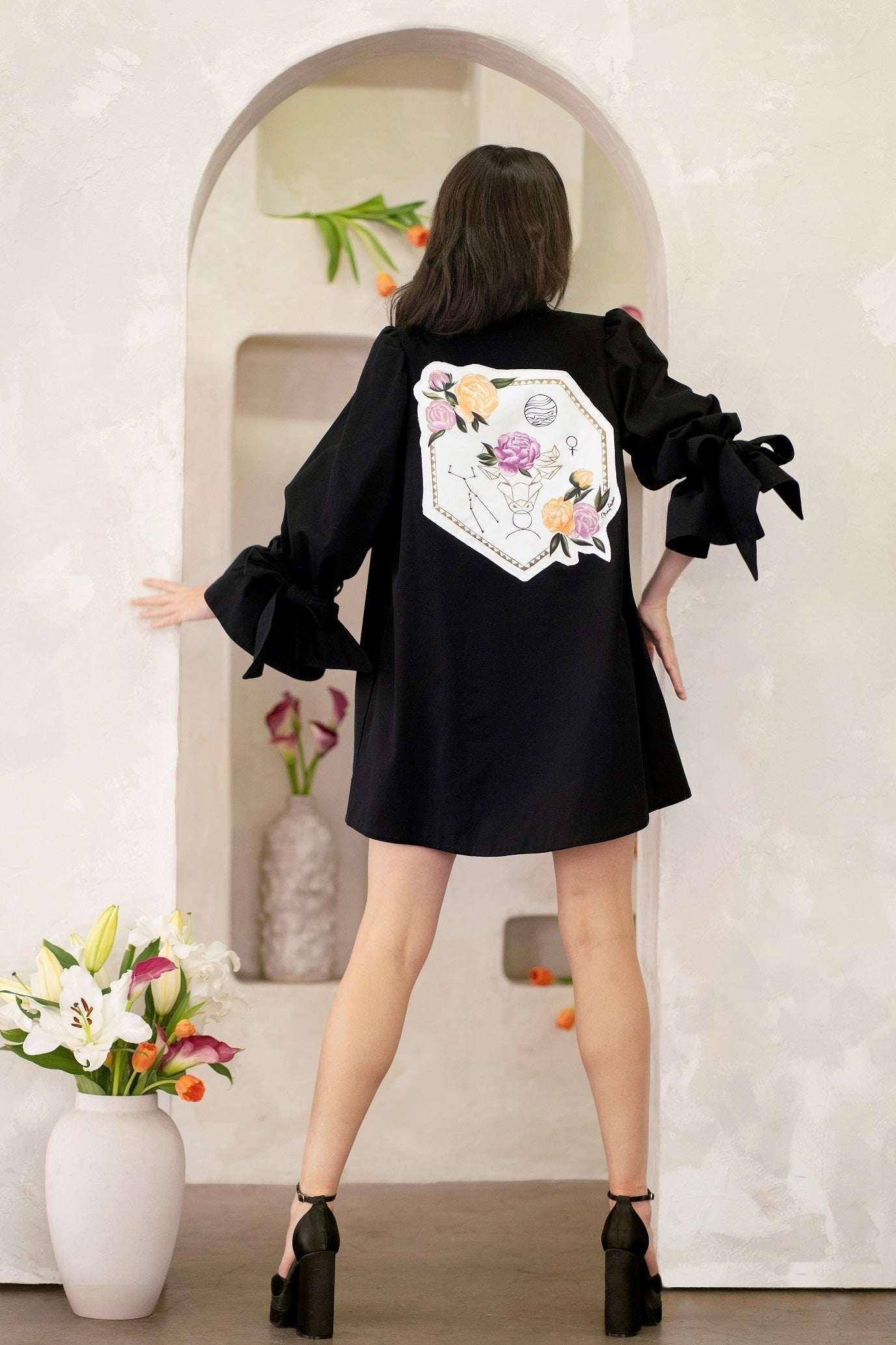 Women wearing a hand-painted Women Taurus Zodiac Jacket with constellation and zodiac symbols on cotton twill fabric