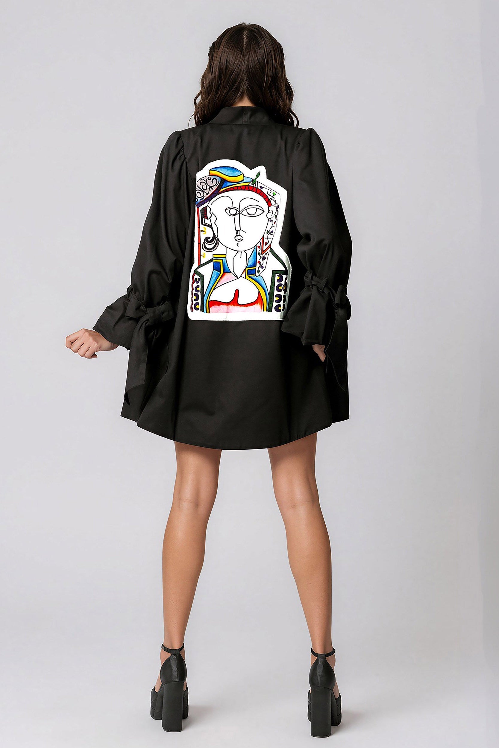 Woman wearing Picasso The Queen Masterpiece Jacket featuring hand-painted Picasso-inspired patchwork design