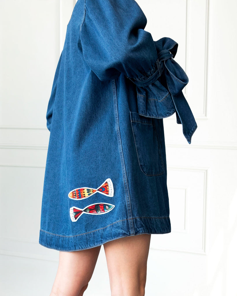 Atelier Flare Denim Jacket in indigo with flared silhouette, patchwork, voluminous sleeves, and front patch pockets made from 100% washed cotton denim