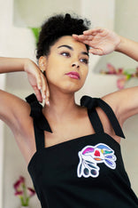 White elegant women's mini dress with hand-painted peace symbols and sleeveless design