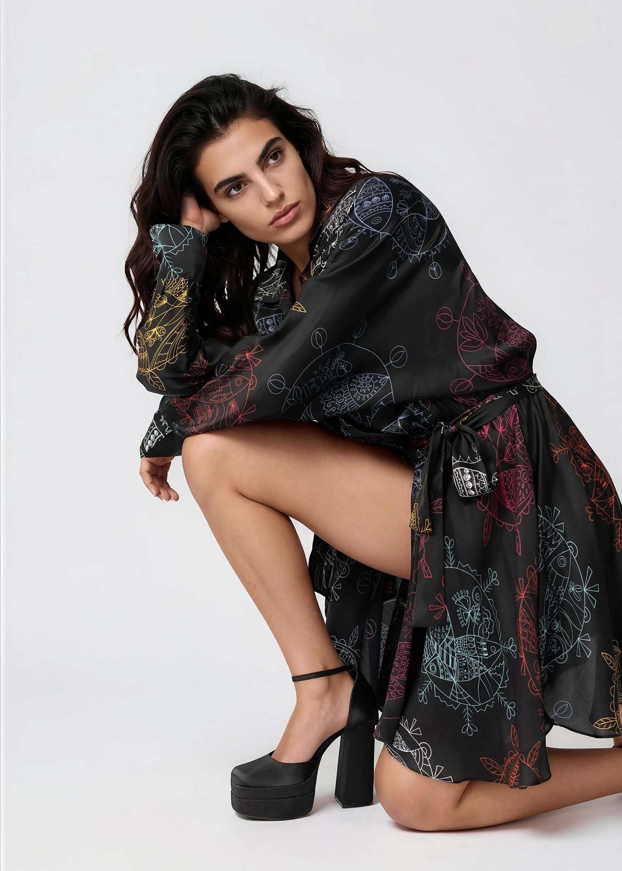 Model wearing flared mini dress with structured collar and long sleeves in Midnight Ocean Dream pattern