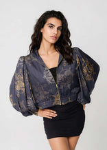 Woman wearing a Twilight Ocean Dream cropped bomber jacket with oversized gathered bell sleeves and front zipper