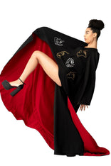 Model wearing Invisible Government Asymmetric Cape and Pants with red lining.