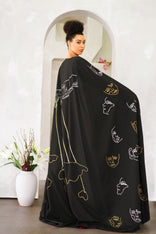 Model wearing Invisible Government Asymmetric Cape and Pants with a hand-painted world map design