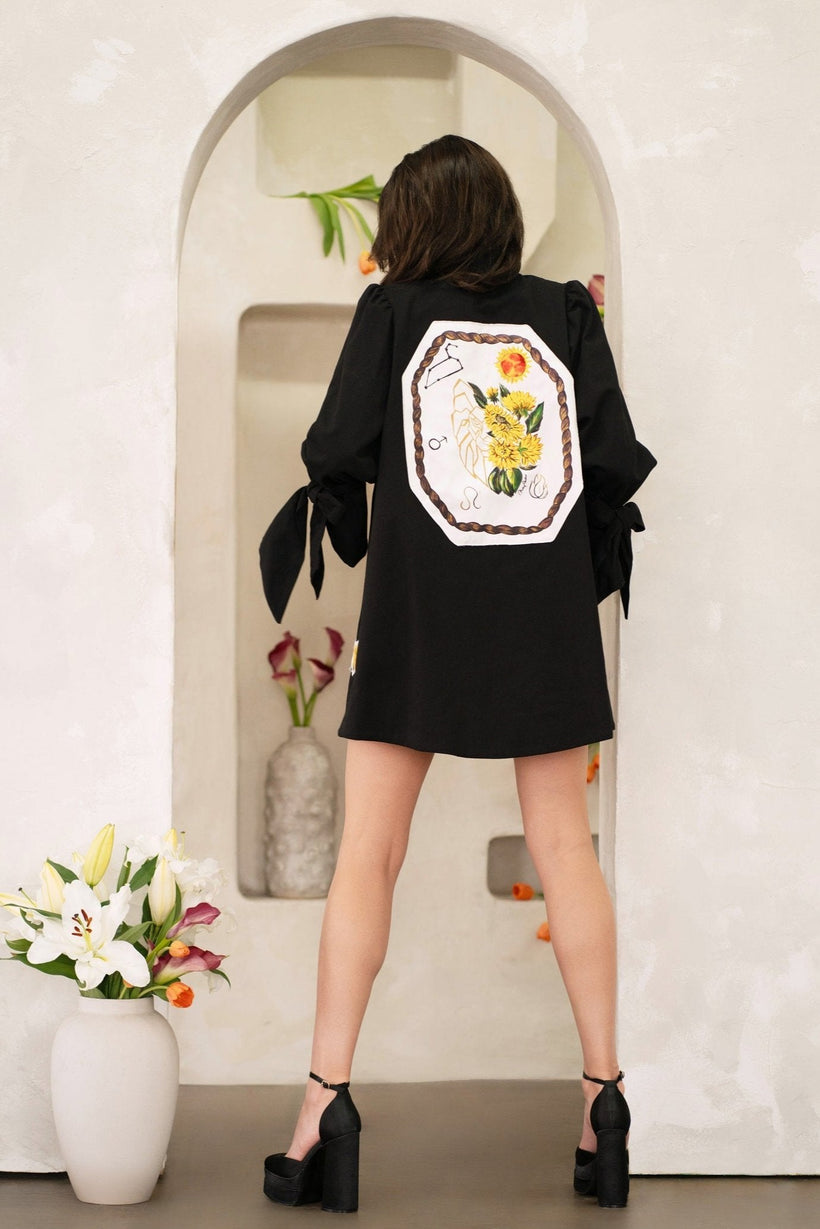 Woman wearing a Women Leo Zodiac Jacket with hand-painted Leo zodiac symbols and constellation patches