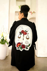Women wearing a flared Libra zodiac jacket with hand-painted zodiac symbol patches and adjustable sleeve straps