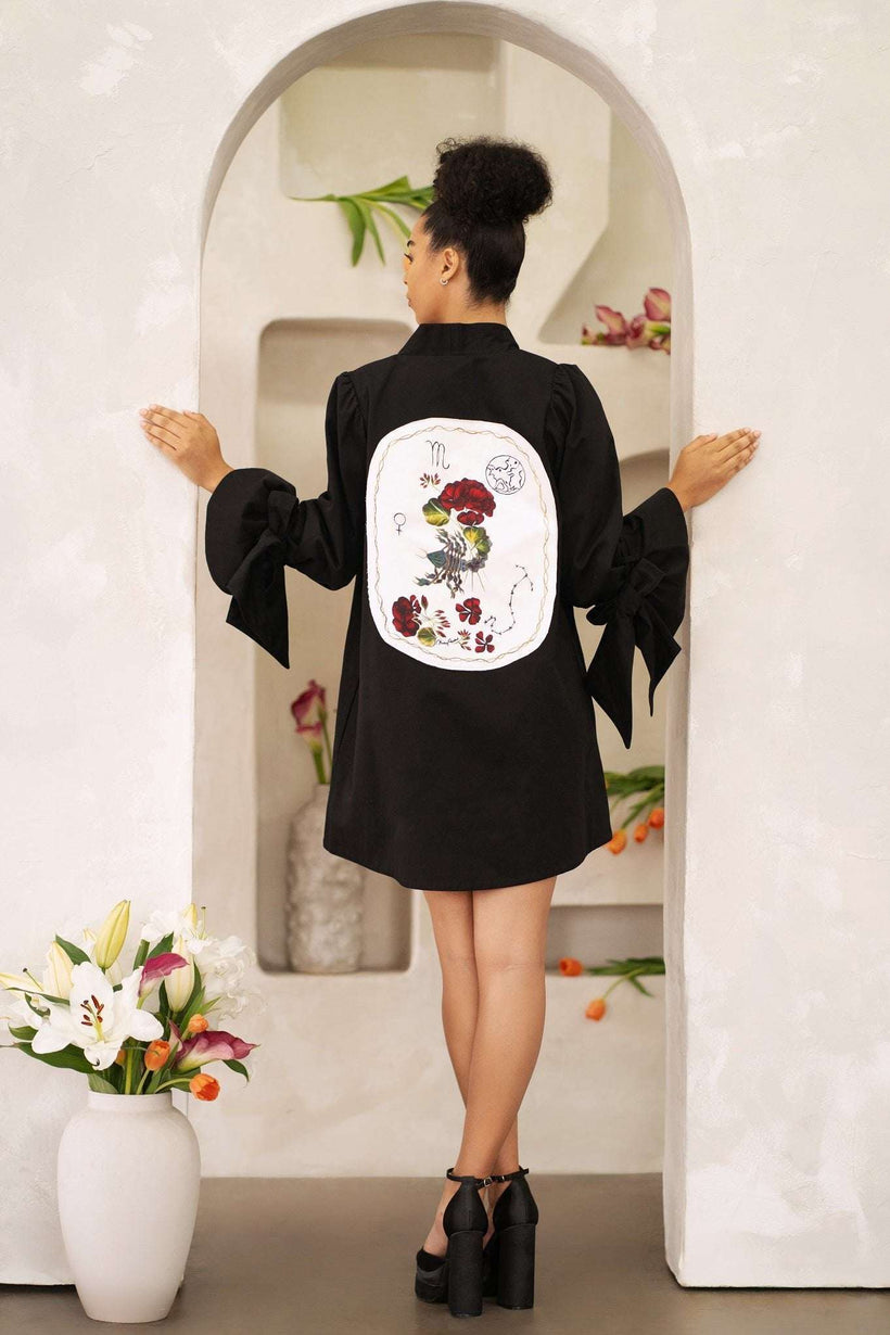 Women wearing a hand-painted Scorpio zodiac jacket with celestial symbols and constellation stars