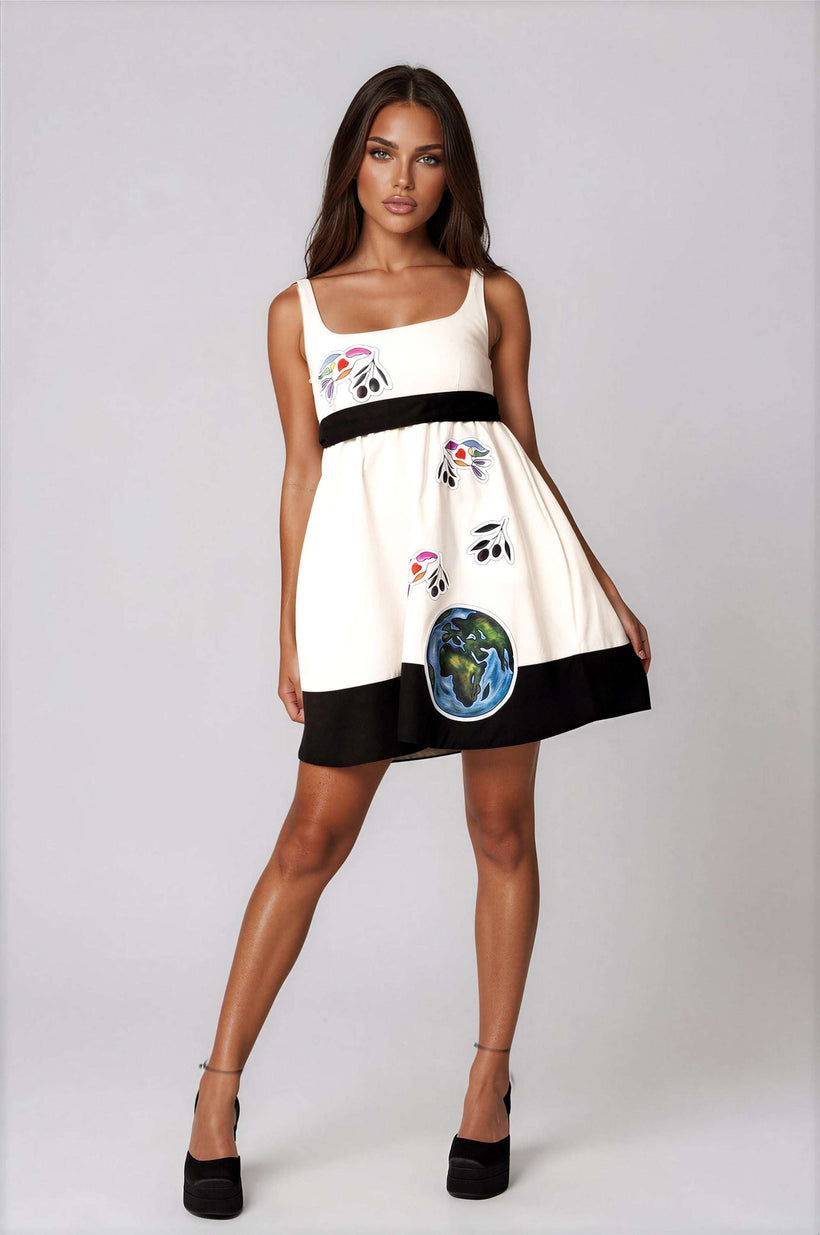 White elegant women's mini dress with peace bird artwork, empire waist, sleeveless, and self-tie belt