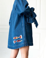 Atelier Flare Denim Jacket in indigo with flared silhouette, patchwork, voluminous sleeves, and front patch pockets made from 100% washed cotton denim
